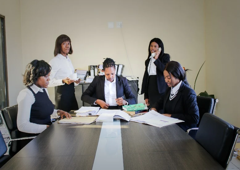 Team members working with documents around an office table